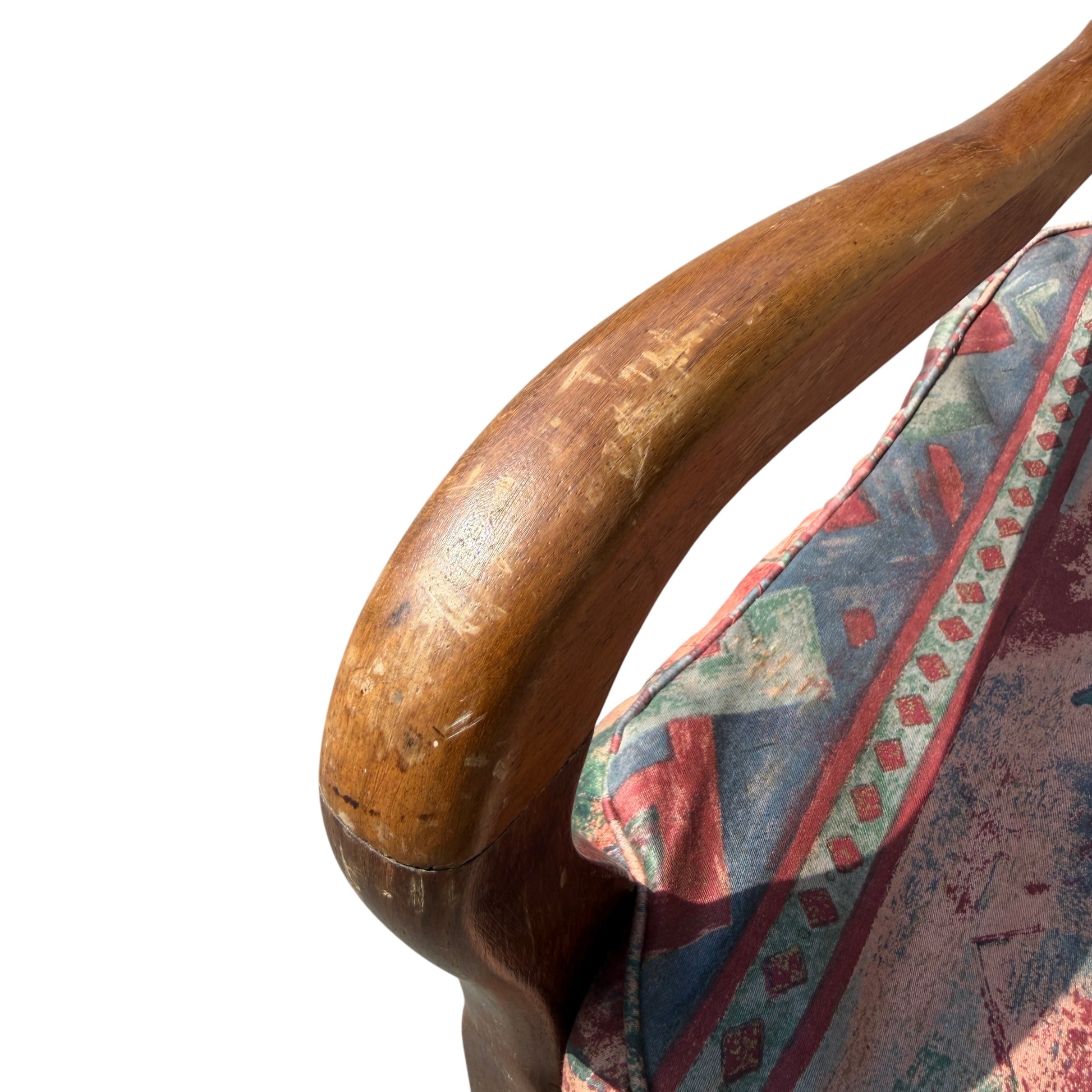 Detail of patterned upholstered seat cushion on vintage wooden armchair