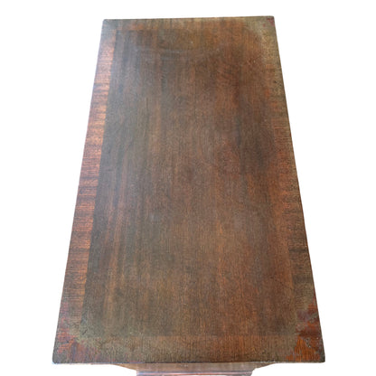 Three-quarter view of wooden chest of drawers in oak finish