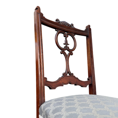 Rear view showing back splats and carved crest of mahogany dining chair