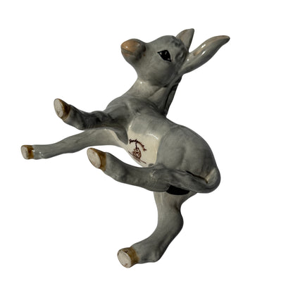 Three-quarter view of Wedgwood ceramic donkey foal figurine showing arched neck