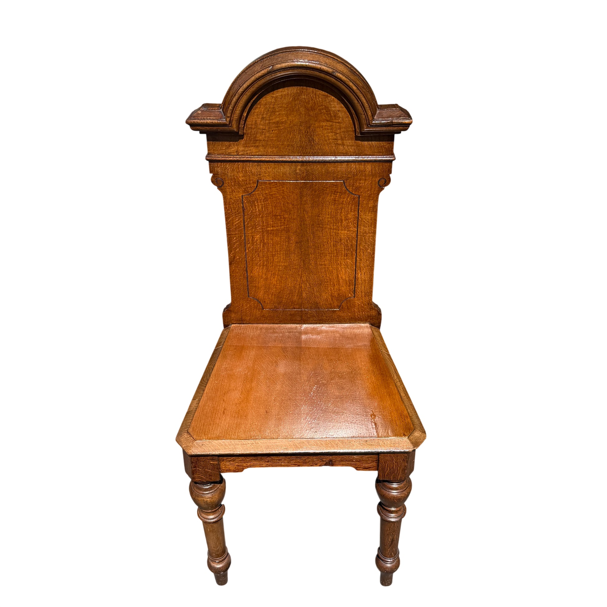 Close-up of carved moulded top and grain detail on oak hall chair back
