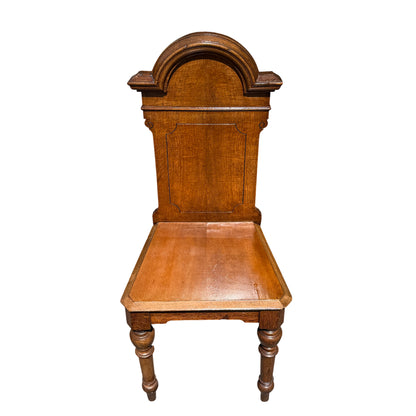 Close-up of carved moulded top and grain detail on oak hall chair back