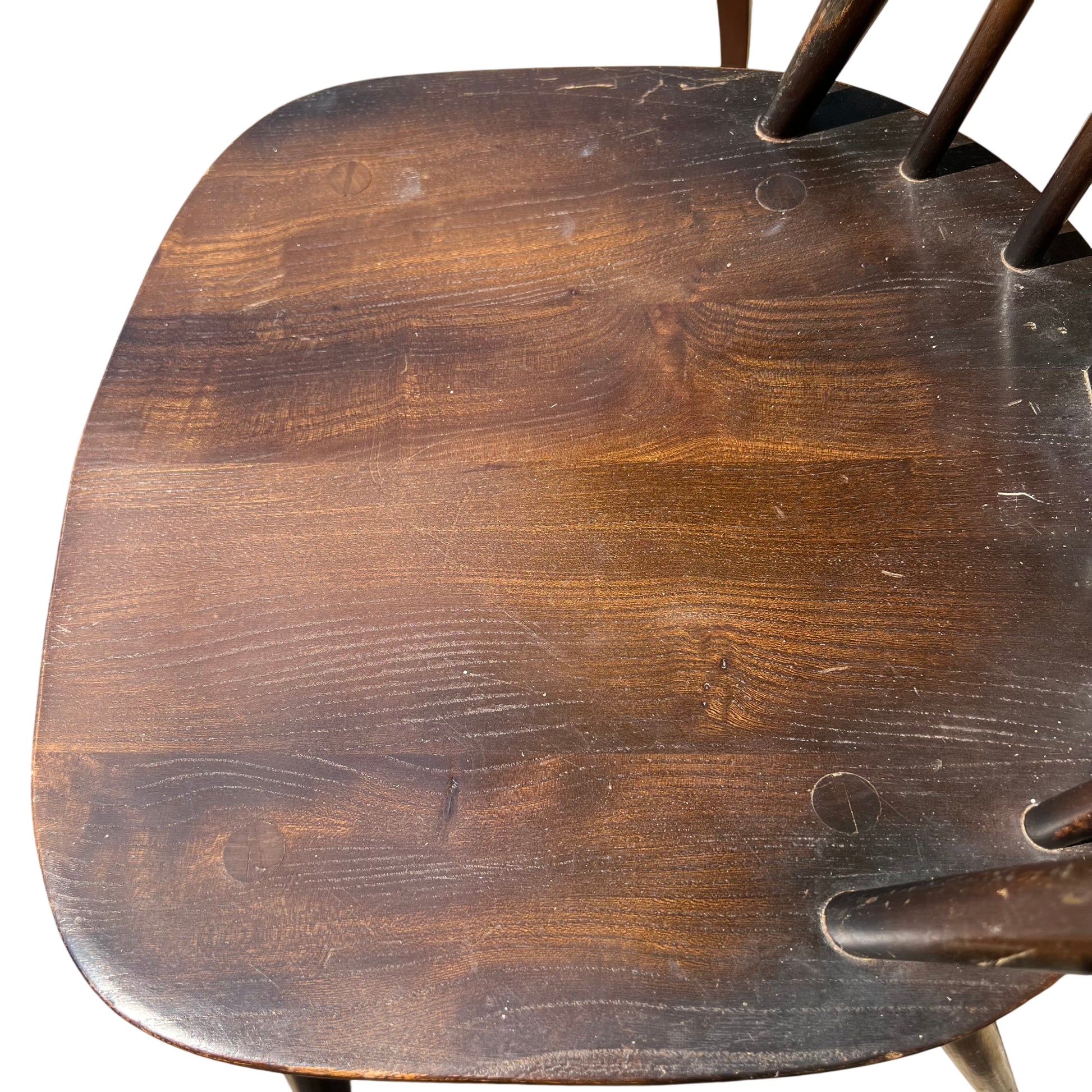 Close-up of tapered front leg and stretcher on vintage wooden dining chair