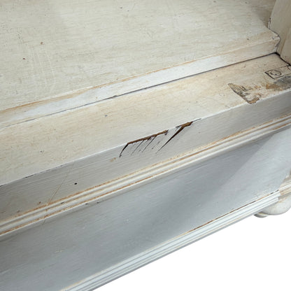 Angled shot of the French painted cabinet standing outside a vintage shop