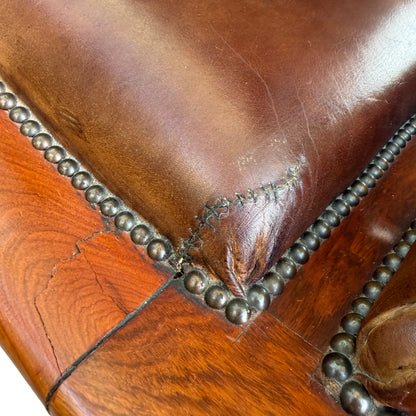 Side view of a Regency chaise longue with curved scroll arm and wooden legs