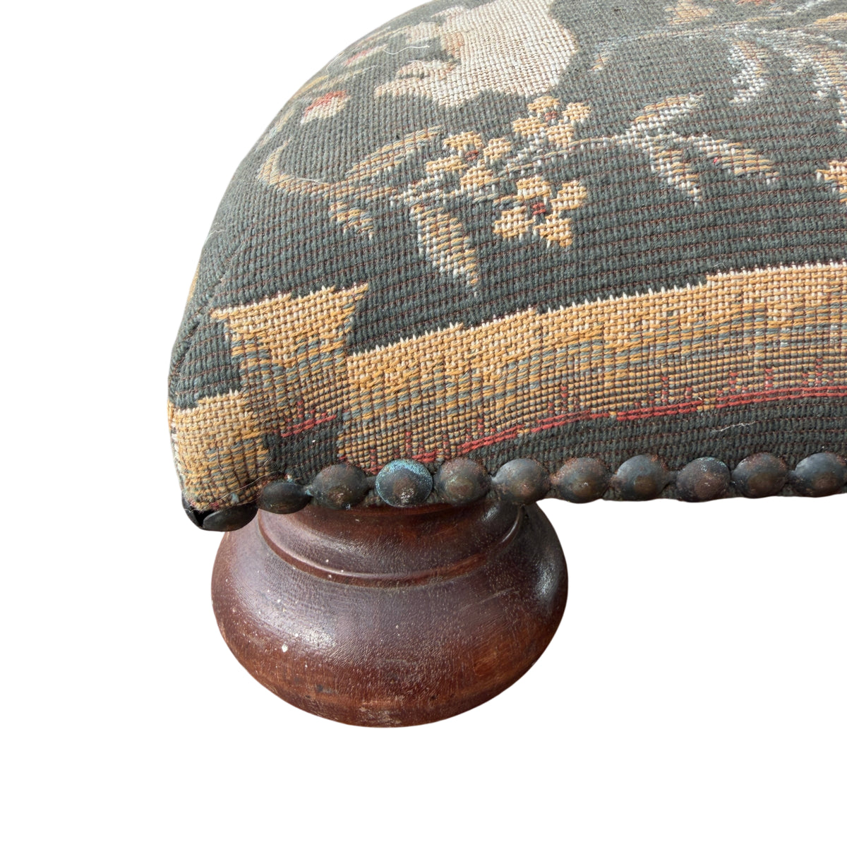 Woven textile close-up showing rabbit and floral details on footstool upholstery