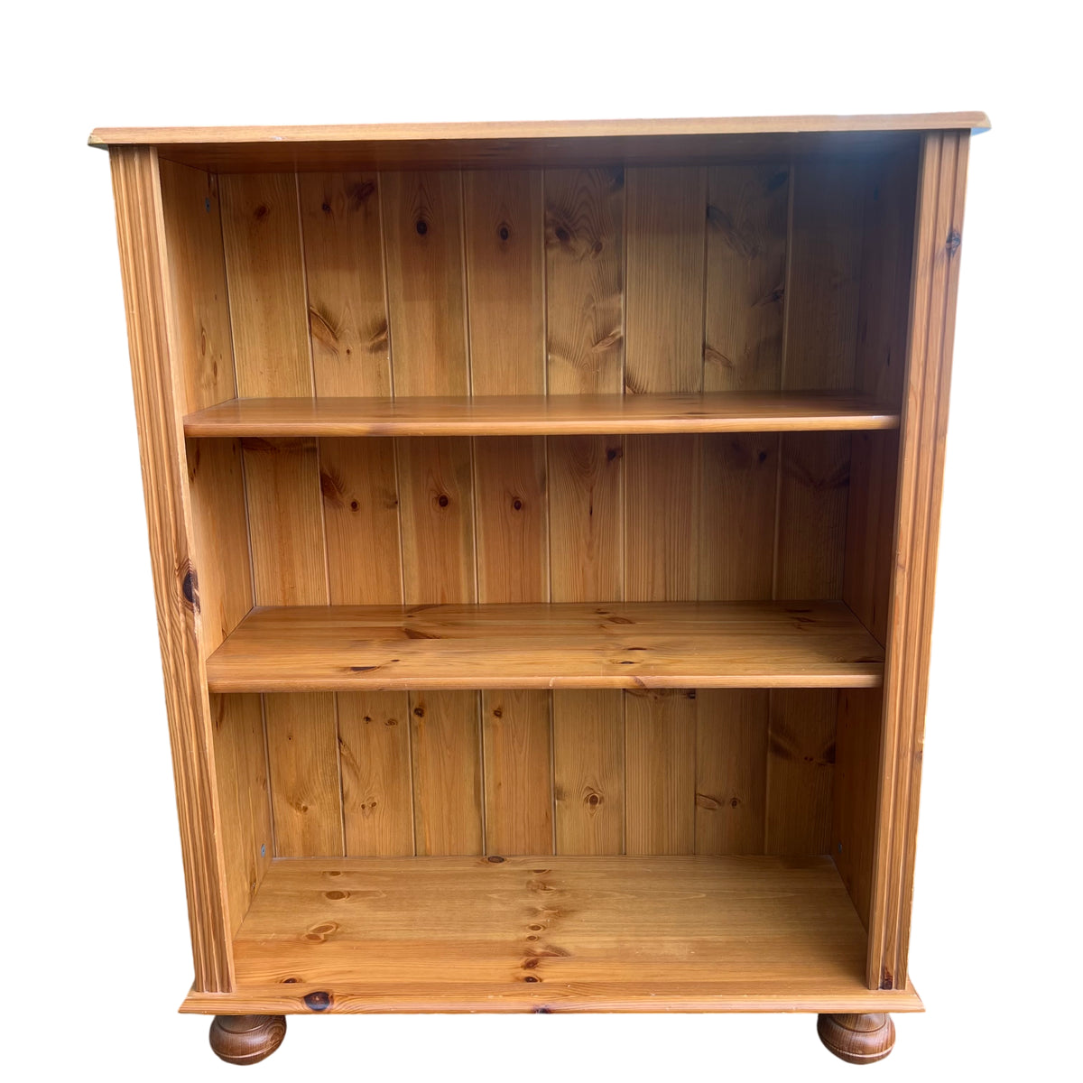 Compact pine bookcase with open shelving and natural finish