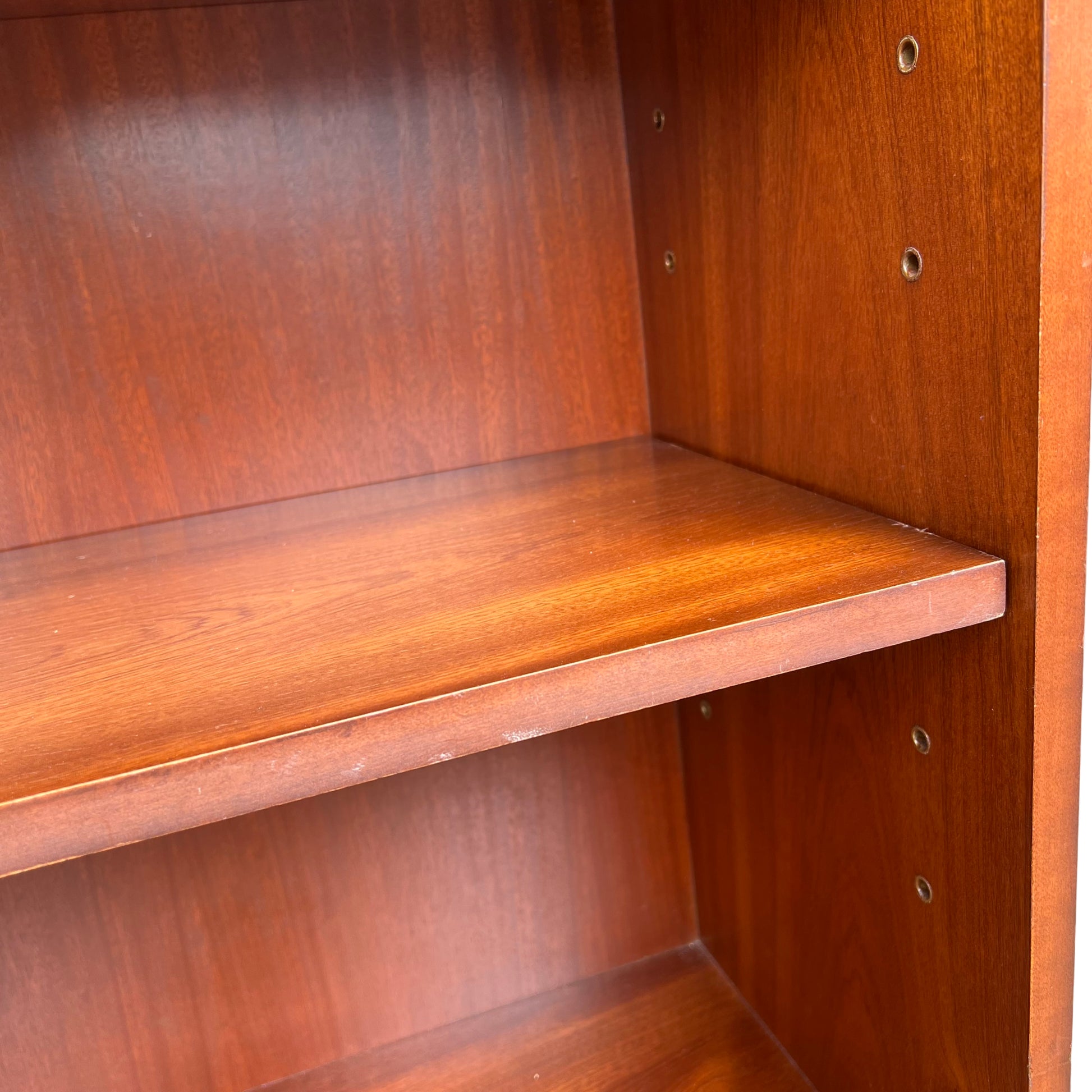 Base plinth and moulded foot of Brights of Nettlebed mahogany bookcase