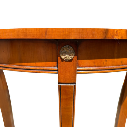 Side view of narrow vintage hall table with tapered legs and demi-lune top