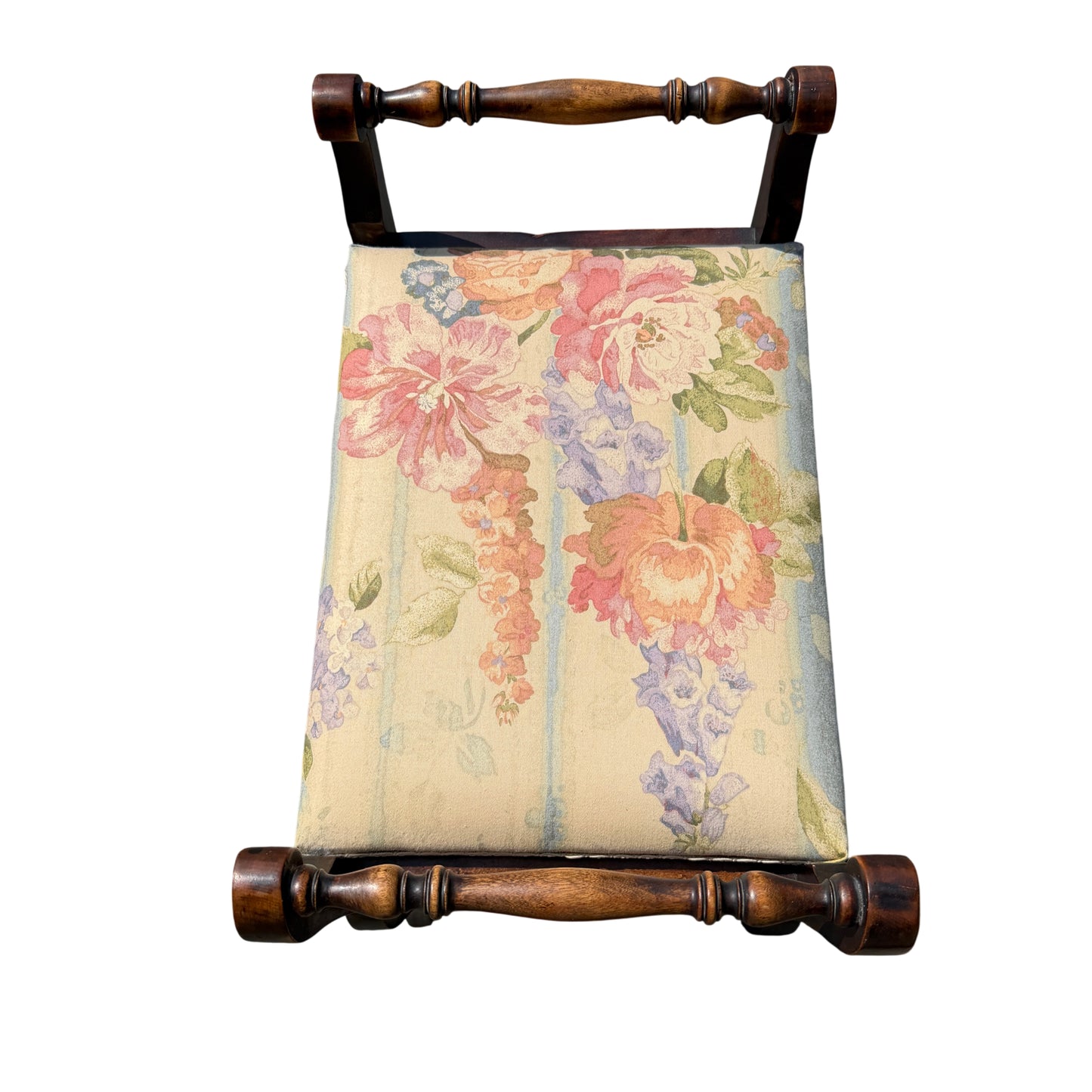 Top-down view of floral upholstered seat on a small Victorian dressing stool