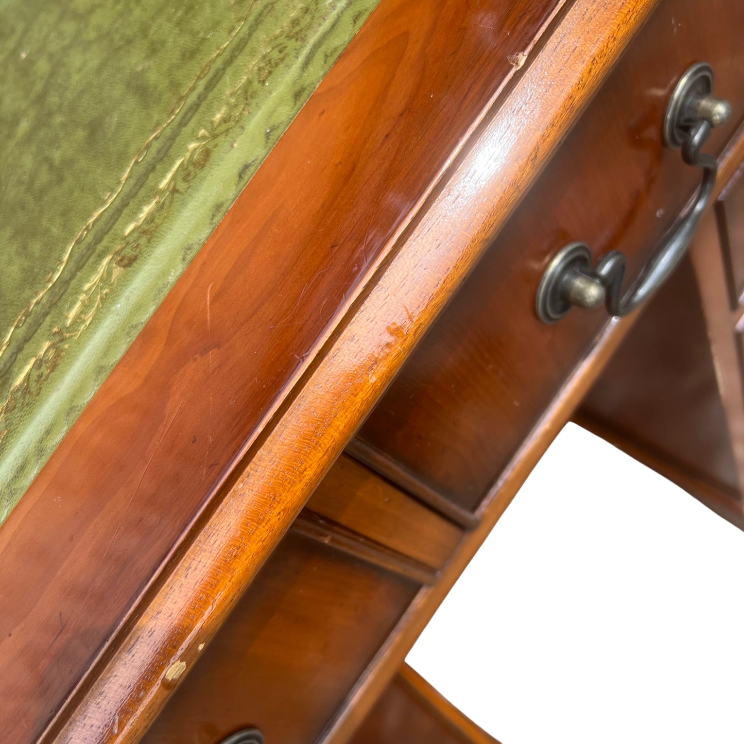 Detail of metal drop handles on vintage desk drawers