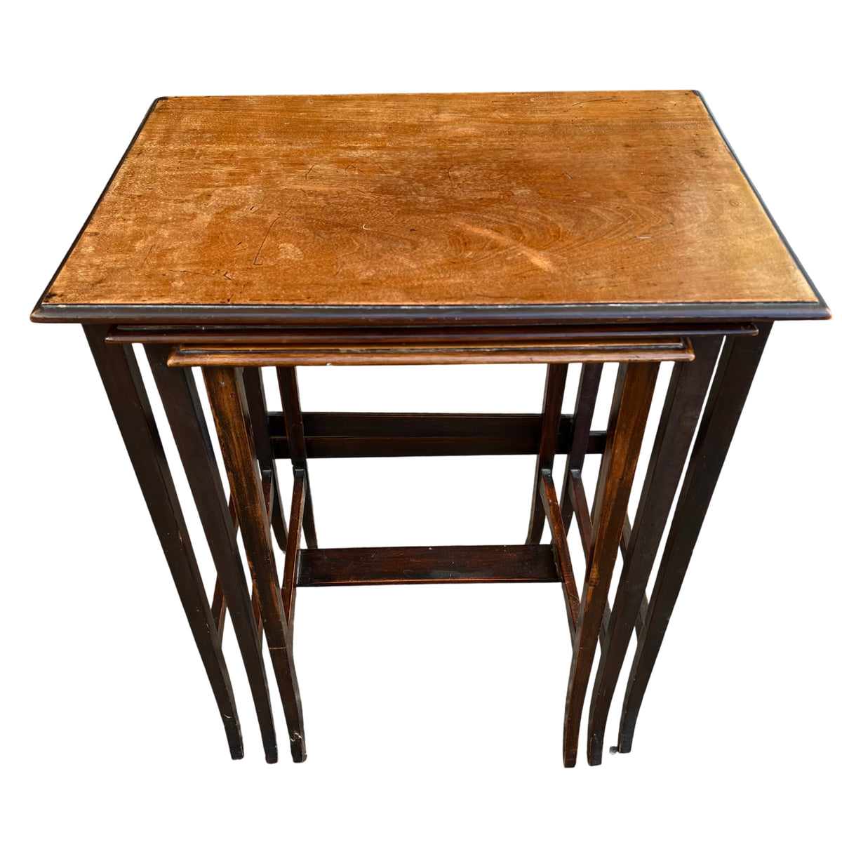 Vintage wooden nest of three tables showing slim slatted legs and stacked arrangement