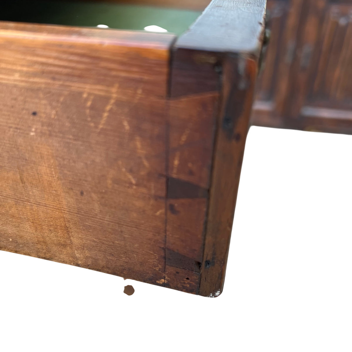 Open drawer lined in green baize inside a small vintage side table