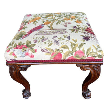 Victorian carved mahogany upholstered stool with patterned floral seat and claw-and-ball feet
