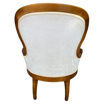 Curved wooden frame and padded seat of upholstered salon chair