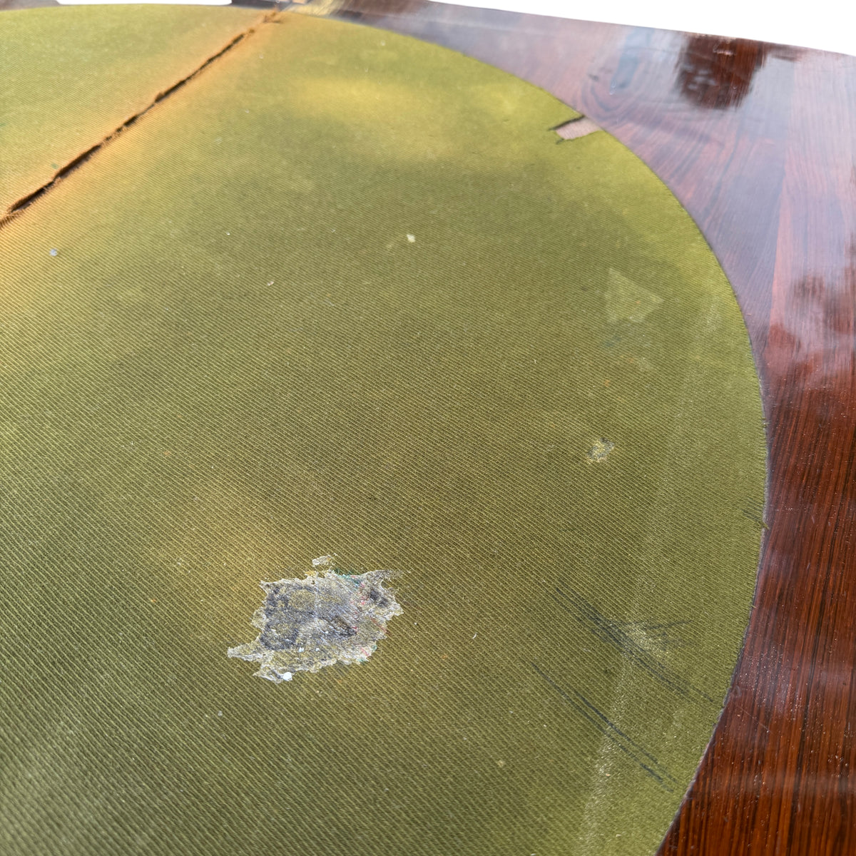 Close-up of baize-lined top seam and worn felt of tilt-top table