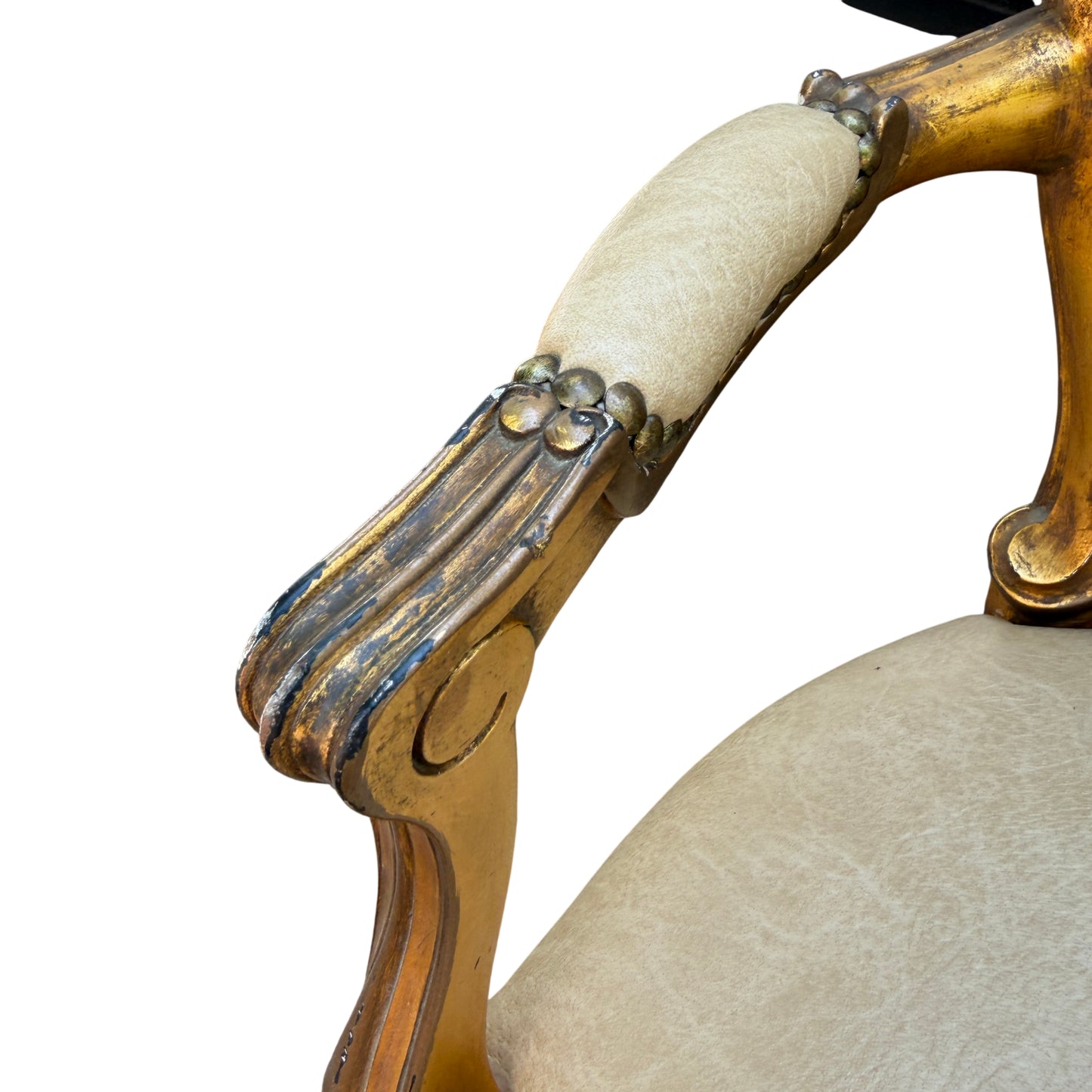Detail of carved gilt wooden apron and floral carving on a Louis-style armchair