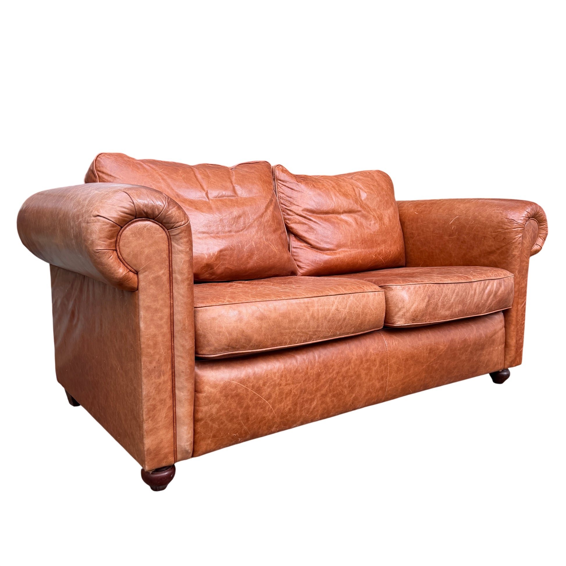 Wesley-Barrell two-seater leather sofa in cognac tan shown outdoors from front angle