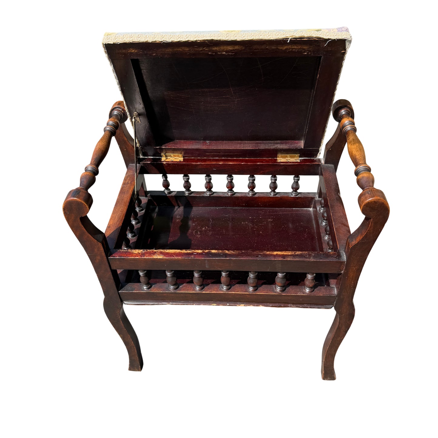 Lower gallery with turned spindles on a Victorian upholstered stool in dark wood