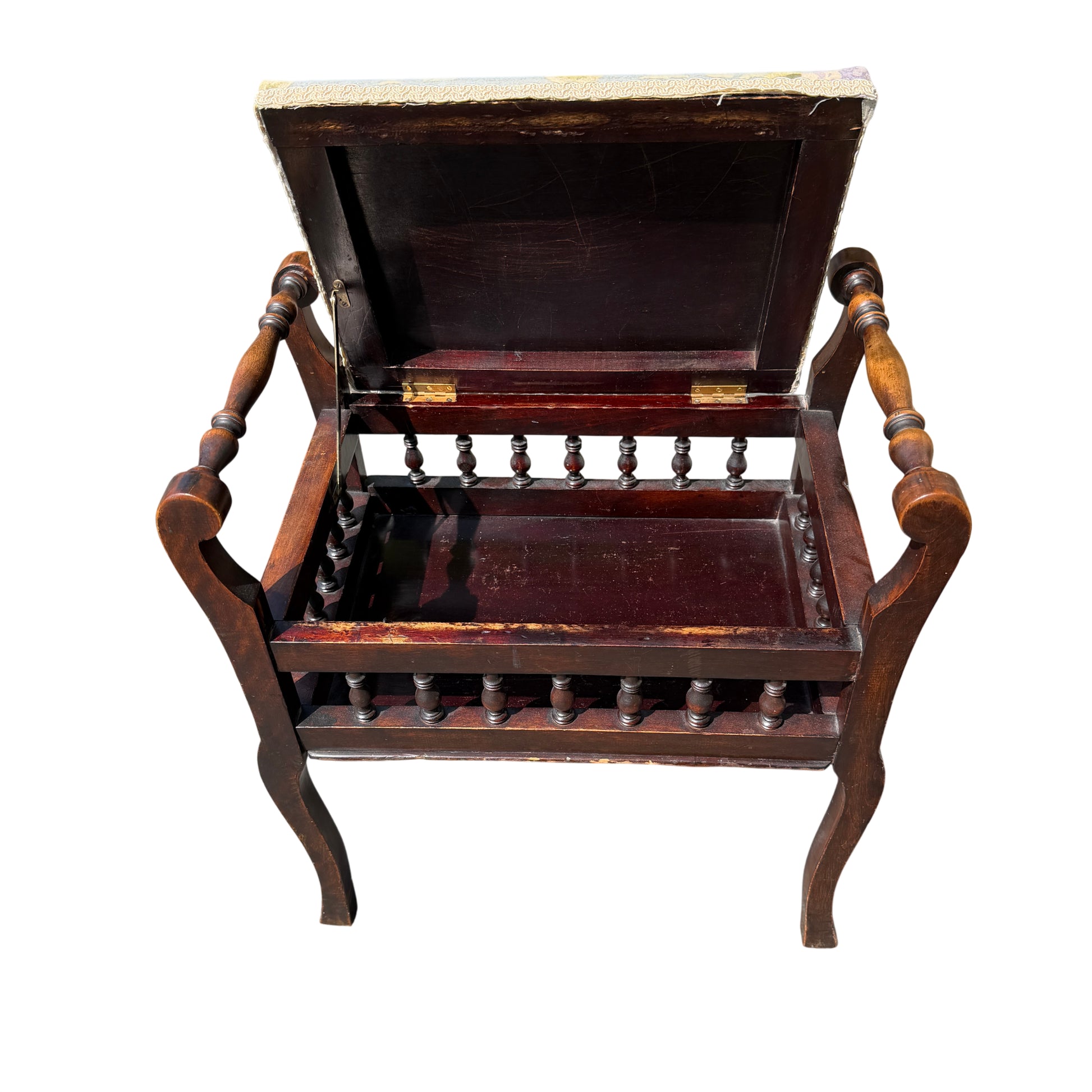 Lower gallery with turned spindles on a Victorian upholstered stool in dark wood