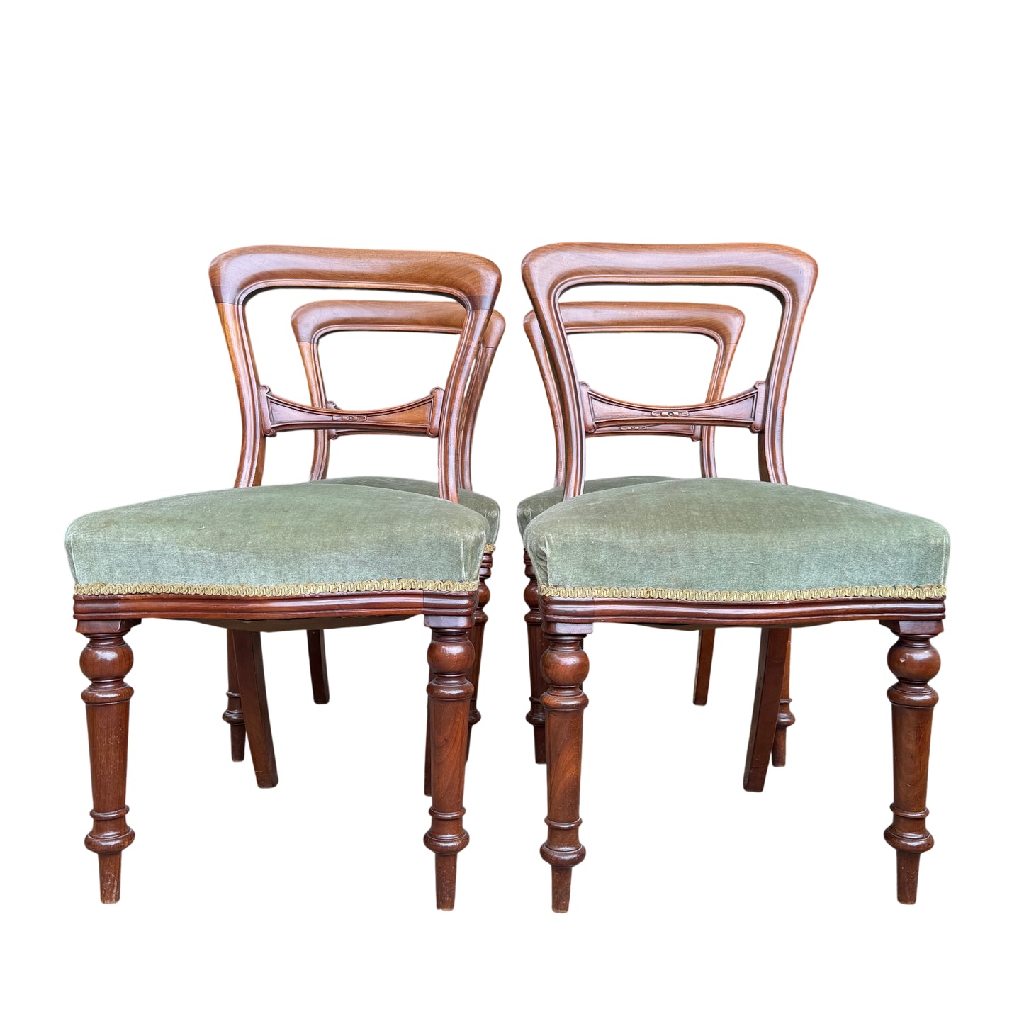 Grouped view of four mahogany Victorian dining chairs showing carved back splats