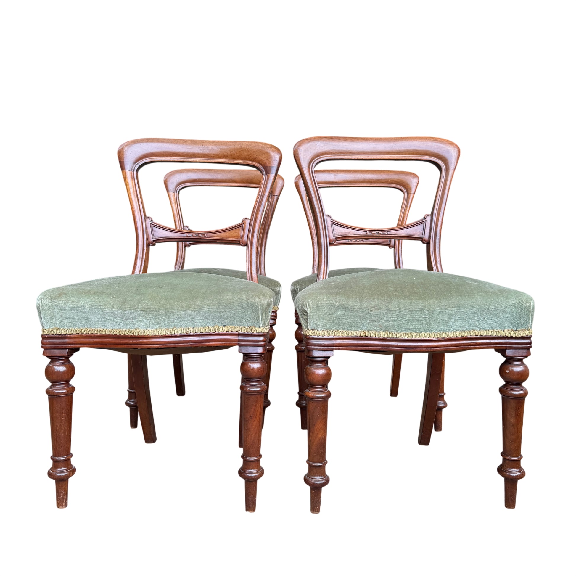 Grouped view of four mahogany Victorian dining chairs showing carved back splats