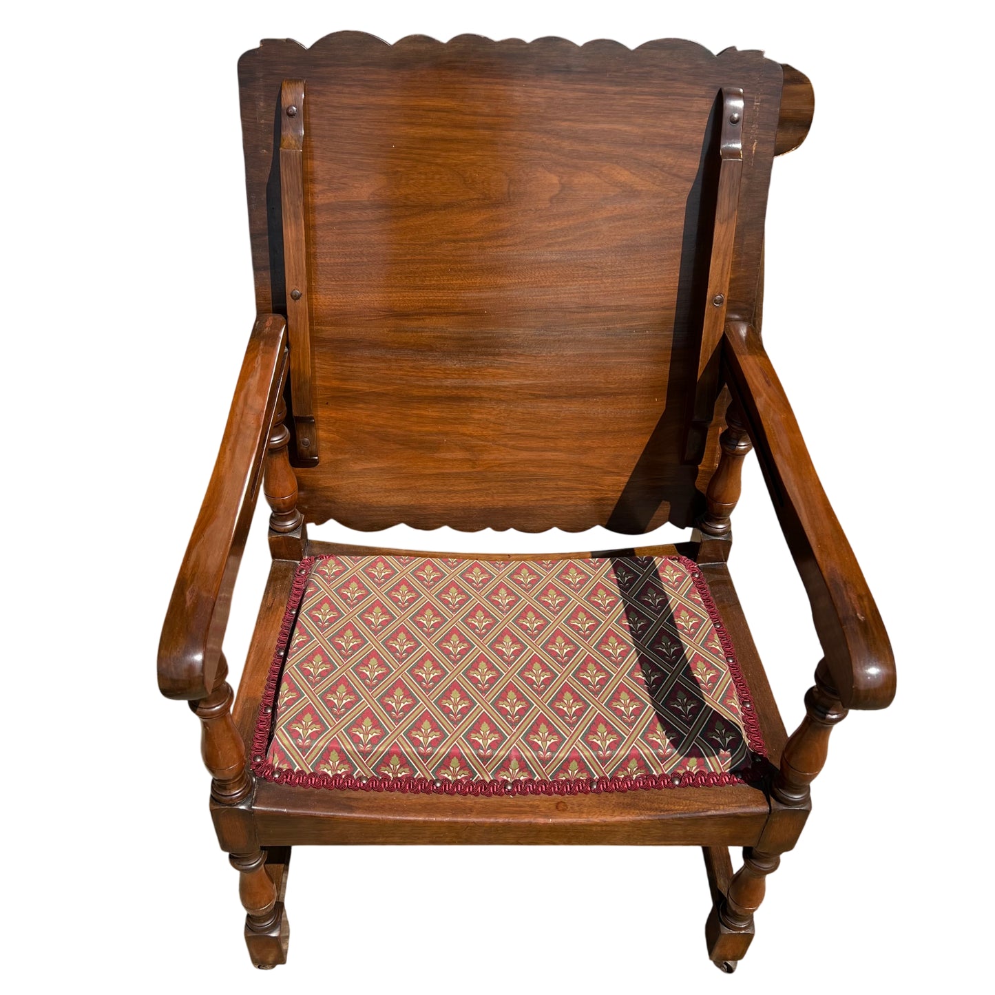 Scalloped back vintage armchair in warm brown wood with upholstered patterned cushion