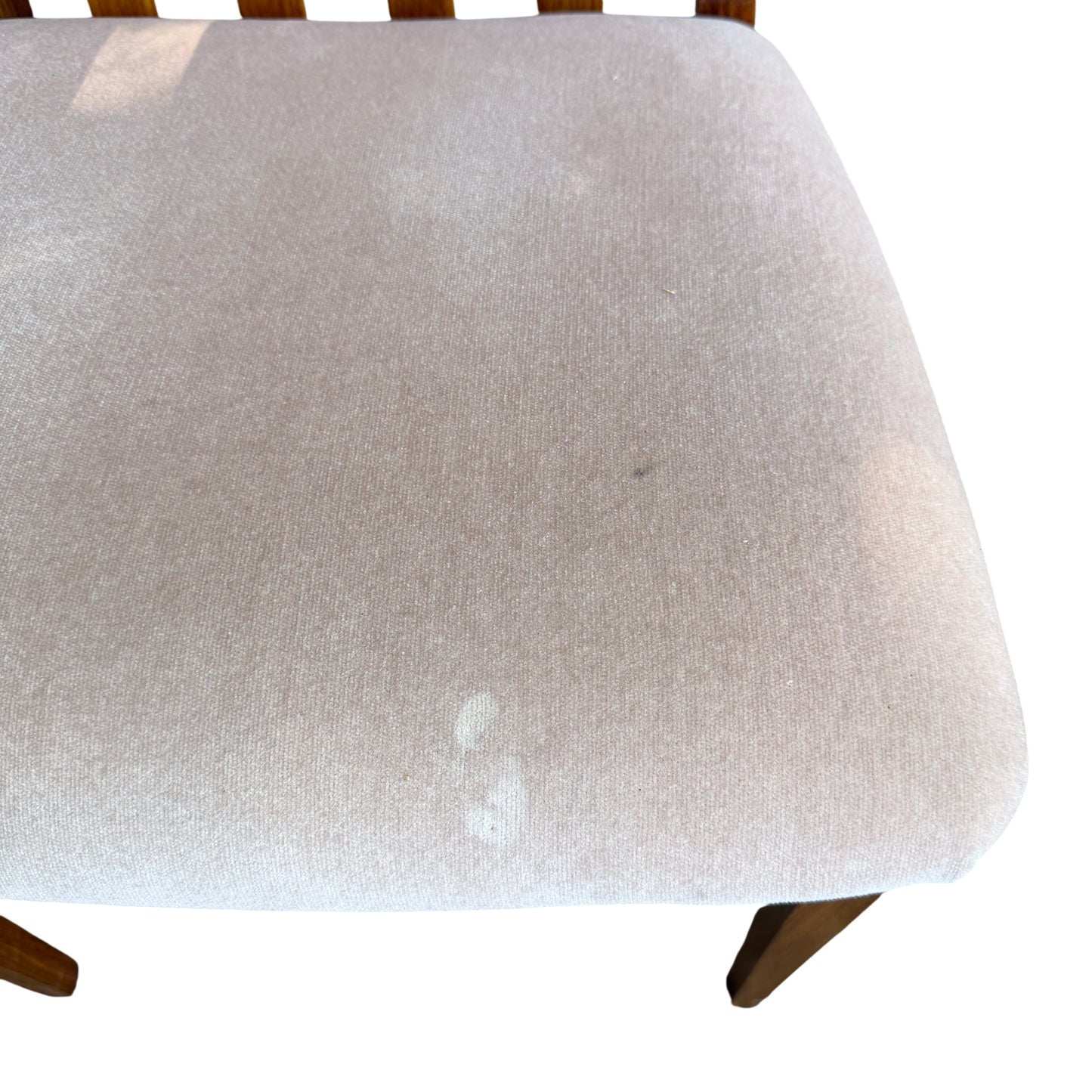 Wooden dining chair leg and scuffed finish visible on a 1970s G-Plan chair