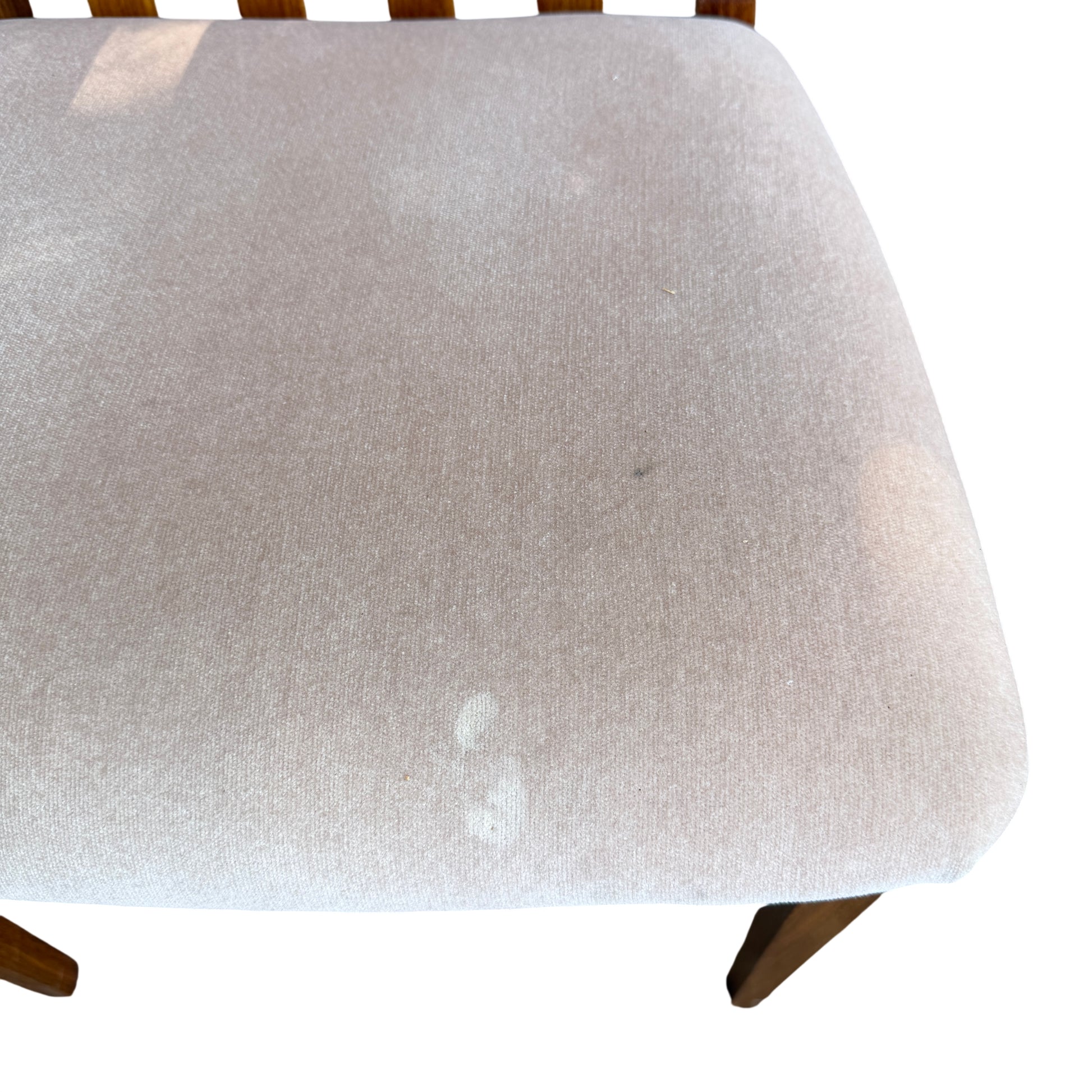 Wooden dining chair leg and scuffed finish visible on a 1970s G-Plan chair