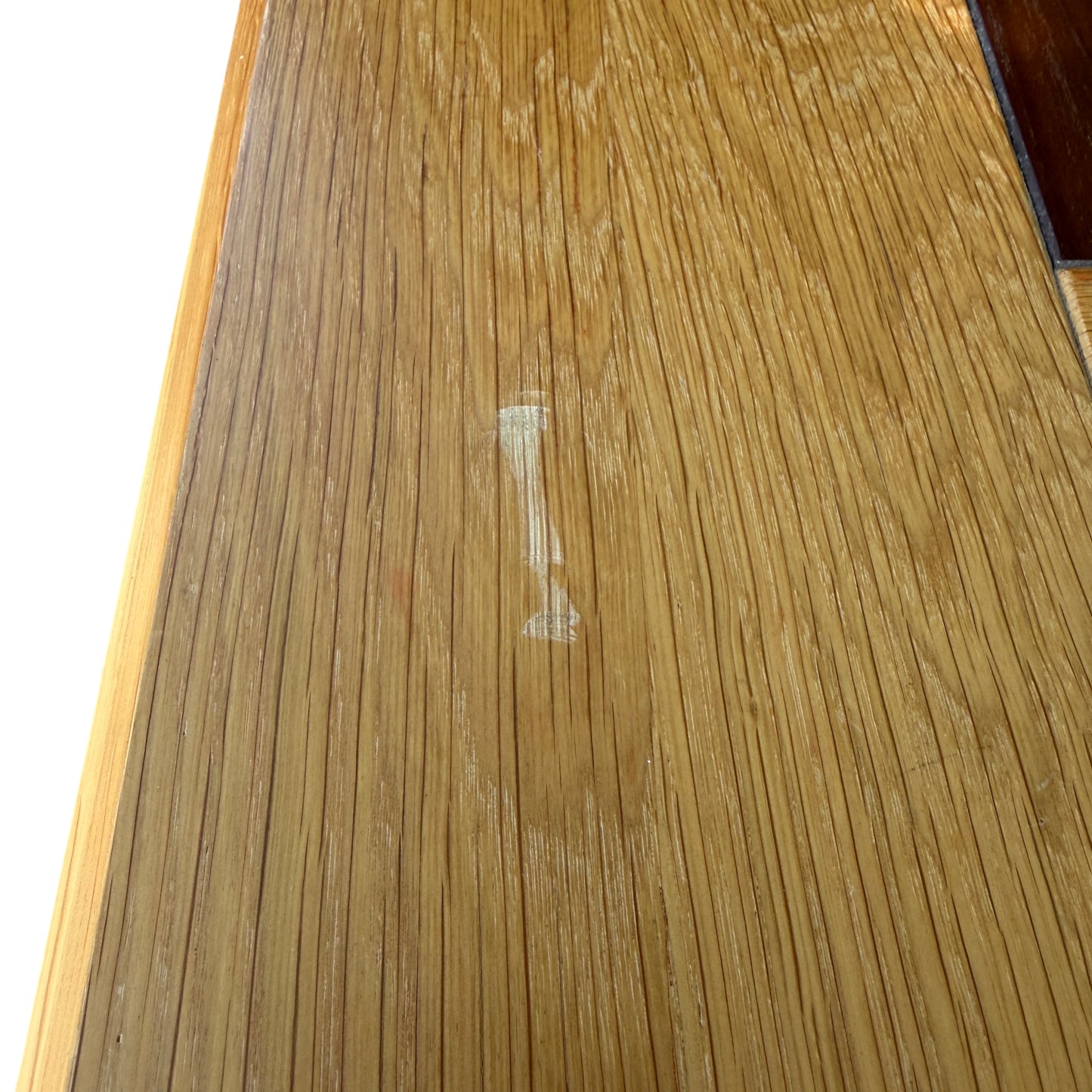 Close-up of leg and lower plinth of solid oak bedside cabinet