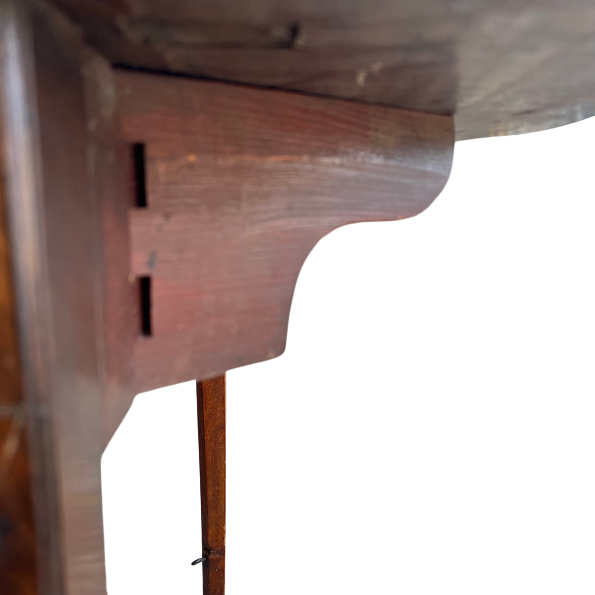 Corner detail of table top showing edge wear and small chip