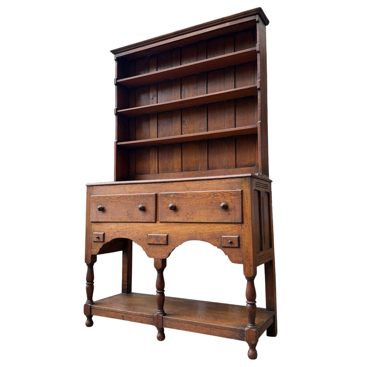 Arts & Crafts oak Welsh dresser with plate‑rack style open shelves and two drawers