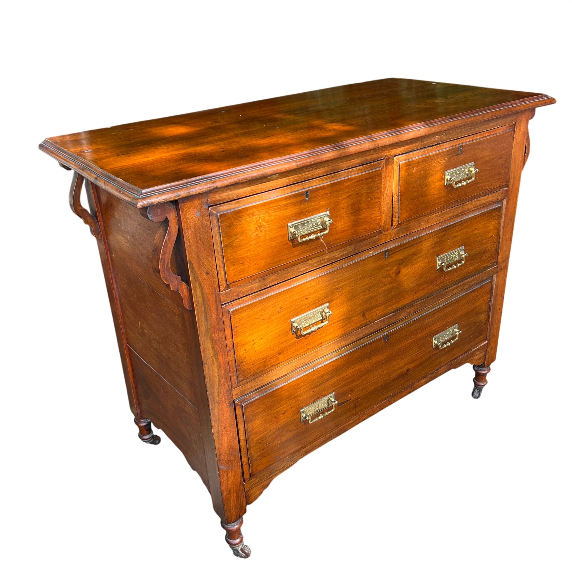 Antique oak chest of drawers with brass handles and decorative side brackets