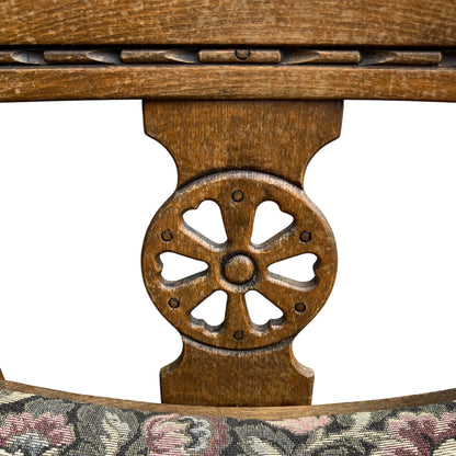 Detail of carved wheel motif on the back of an Old Charm oak bar stool