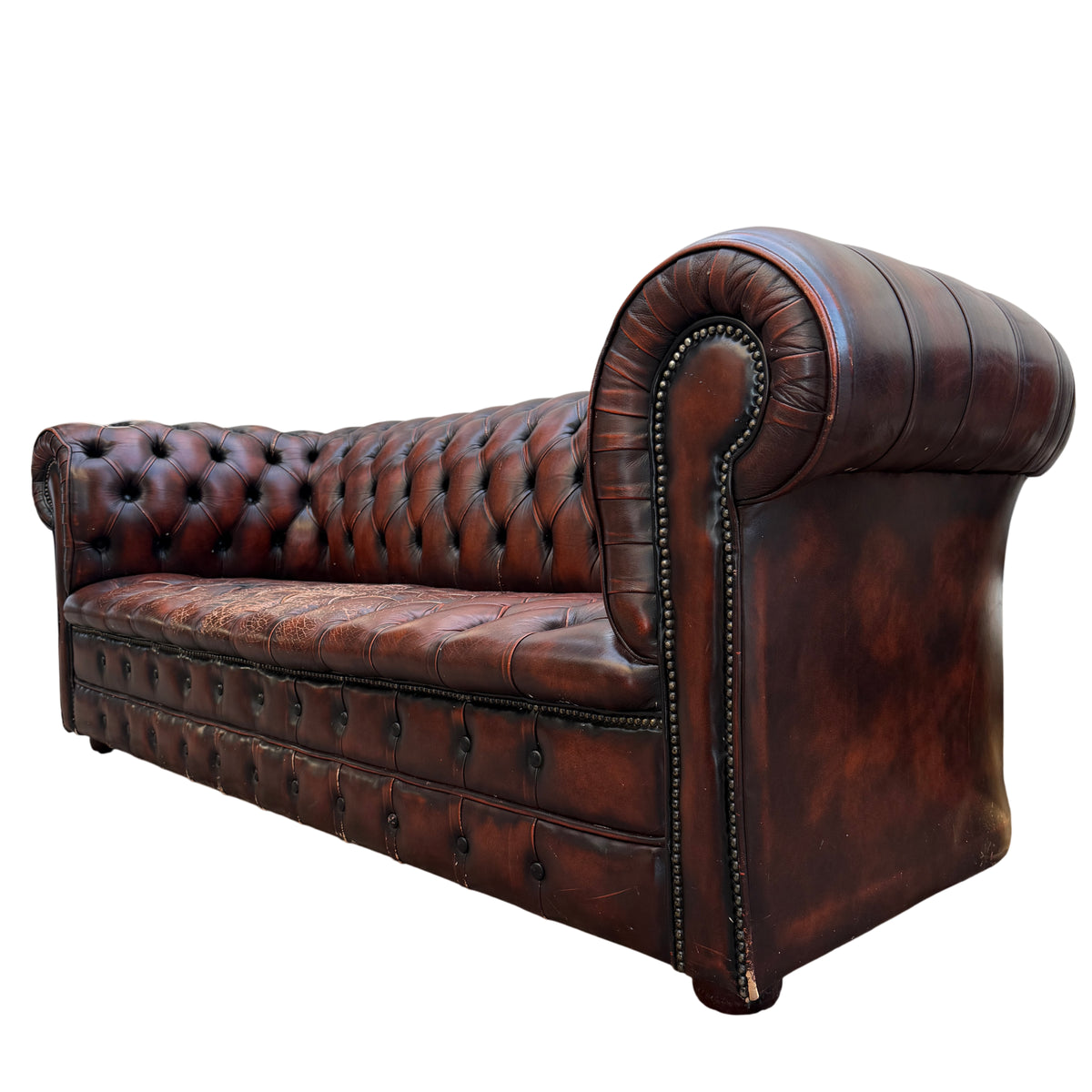 Brown leather Chesterfield sofa with deep button tufting and rolled scrolled arm