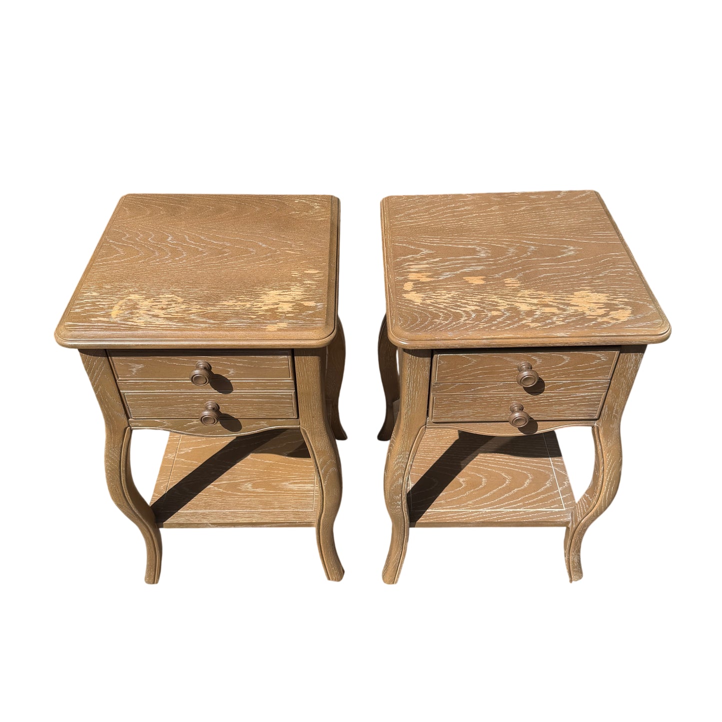 Front view of matching bedside cabinets with round wooden knobs and two drawers