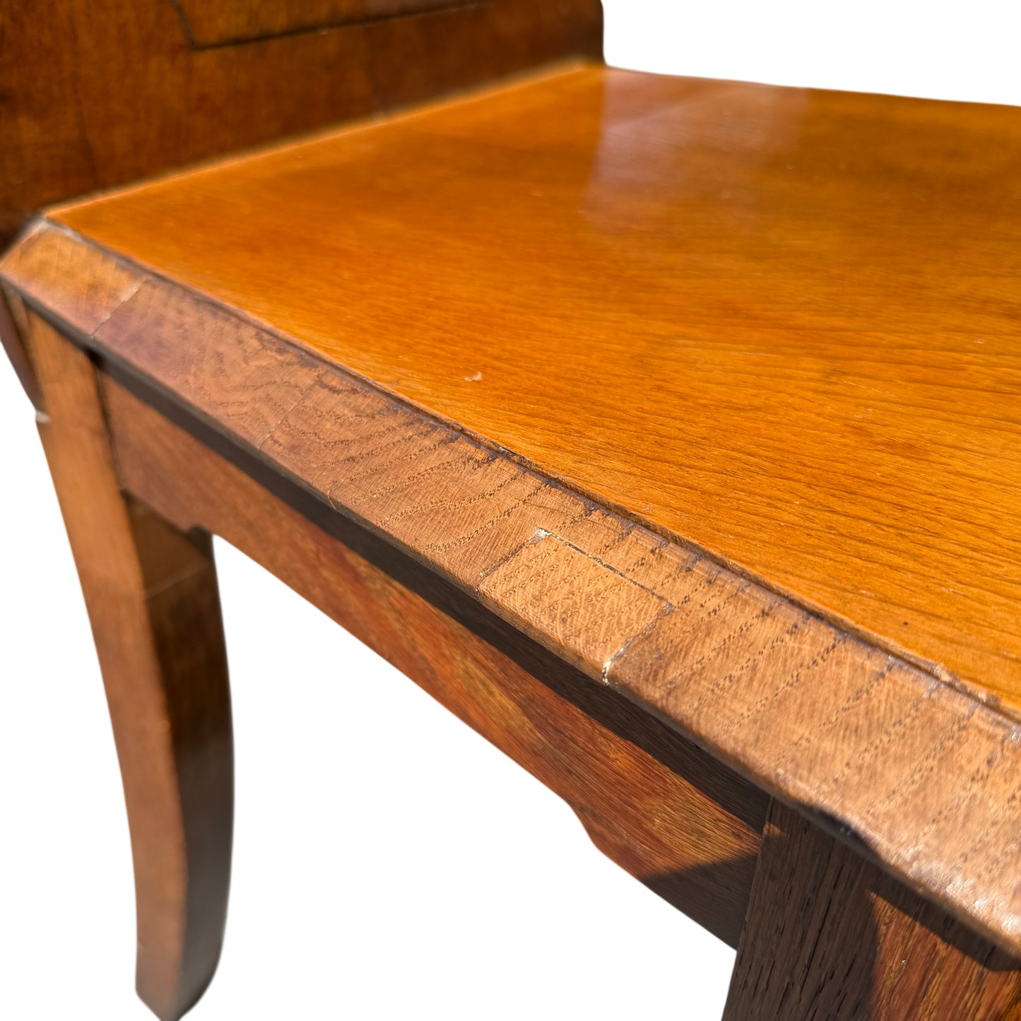 Looking over two oak chairs showing matching carved backs and finish