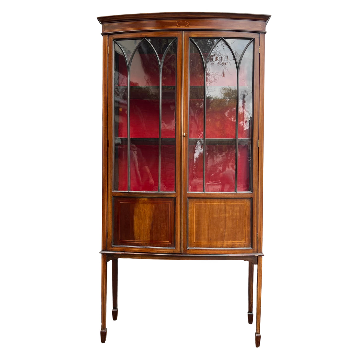 Slim Edwardian glazed display cabinet on tall tapered legs with inlaid stringing