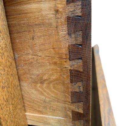 Lower base of oak chest showing moulding and bun foot wear