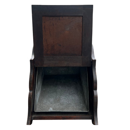 Detailed carved panel on front of wooden coal scuttle with floral and draped carving