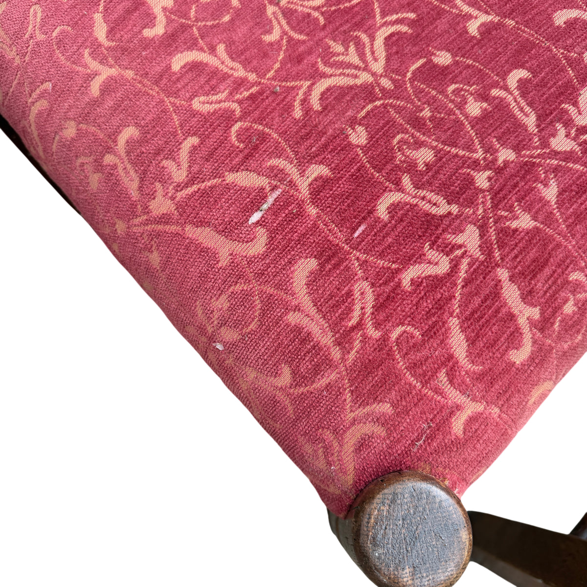 Worn oak armrest and finial detail on a vintage dining chair