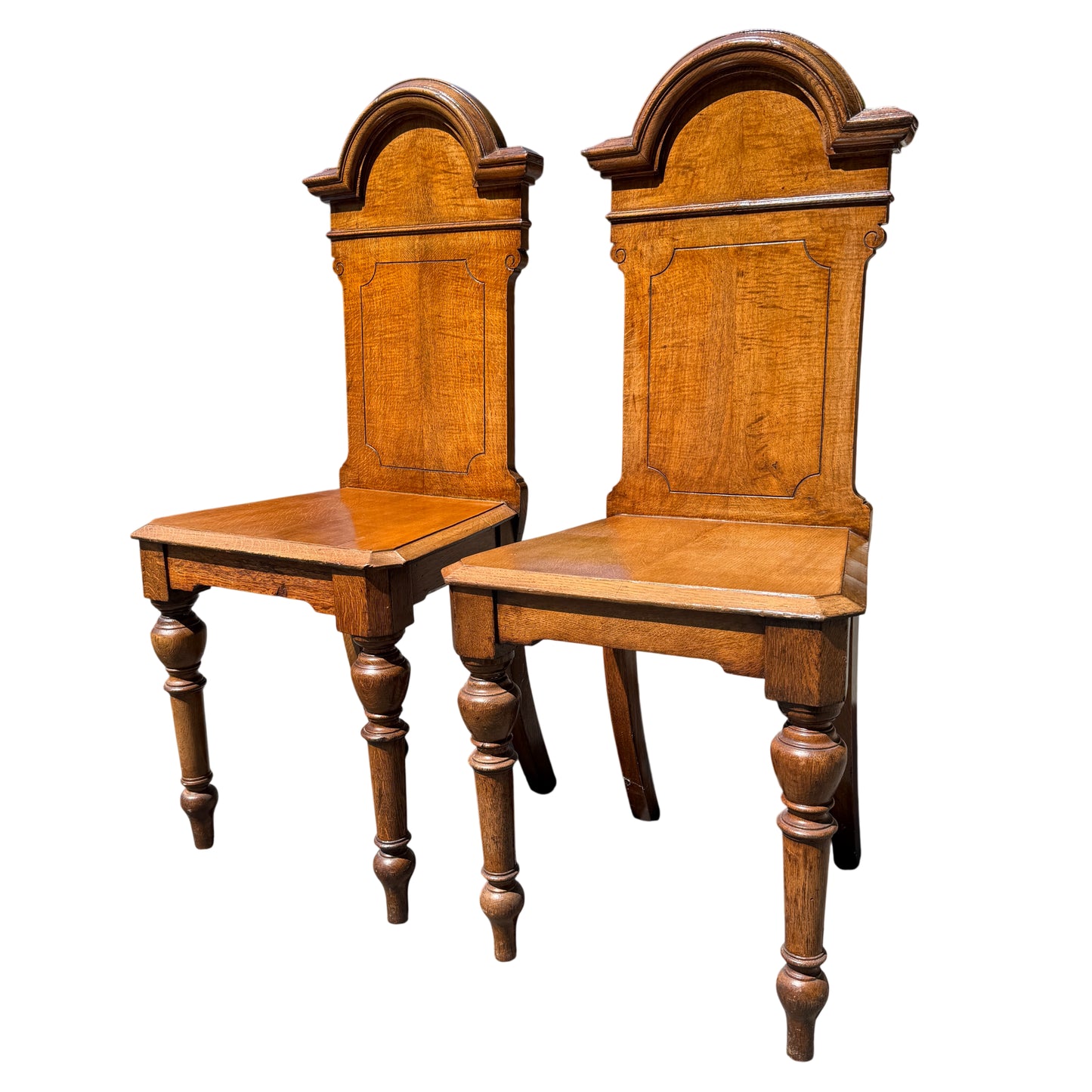 Pair of late Victorian oak hall chairs with turned legs and tall moulded backs