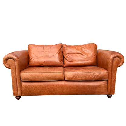 Front view two-seater leather sofa Wesley-Barrell in cognac tan with plump cushions