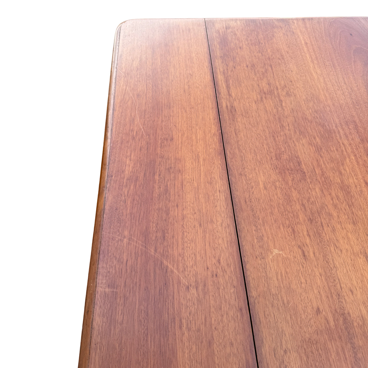 Top-down view of three-panel wooden top on small extending table