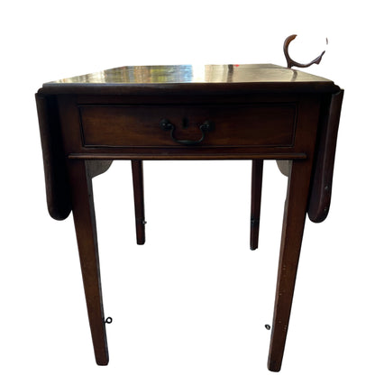 Drop-leaf side table with drawer showing top surface and extension leaves