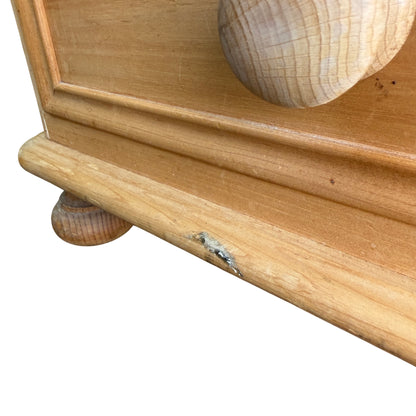 Base moulding and scuff marks on lower edge of pine bedside cabinet