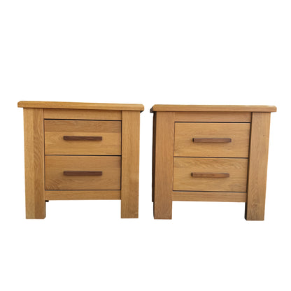 Front view of two oak bedside cabinets with horizontal drawer fronts and darker handles