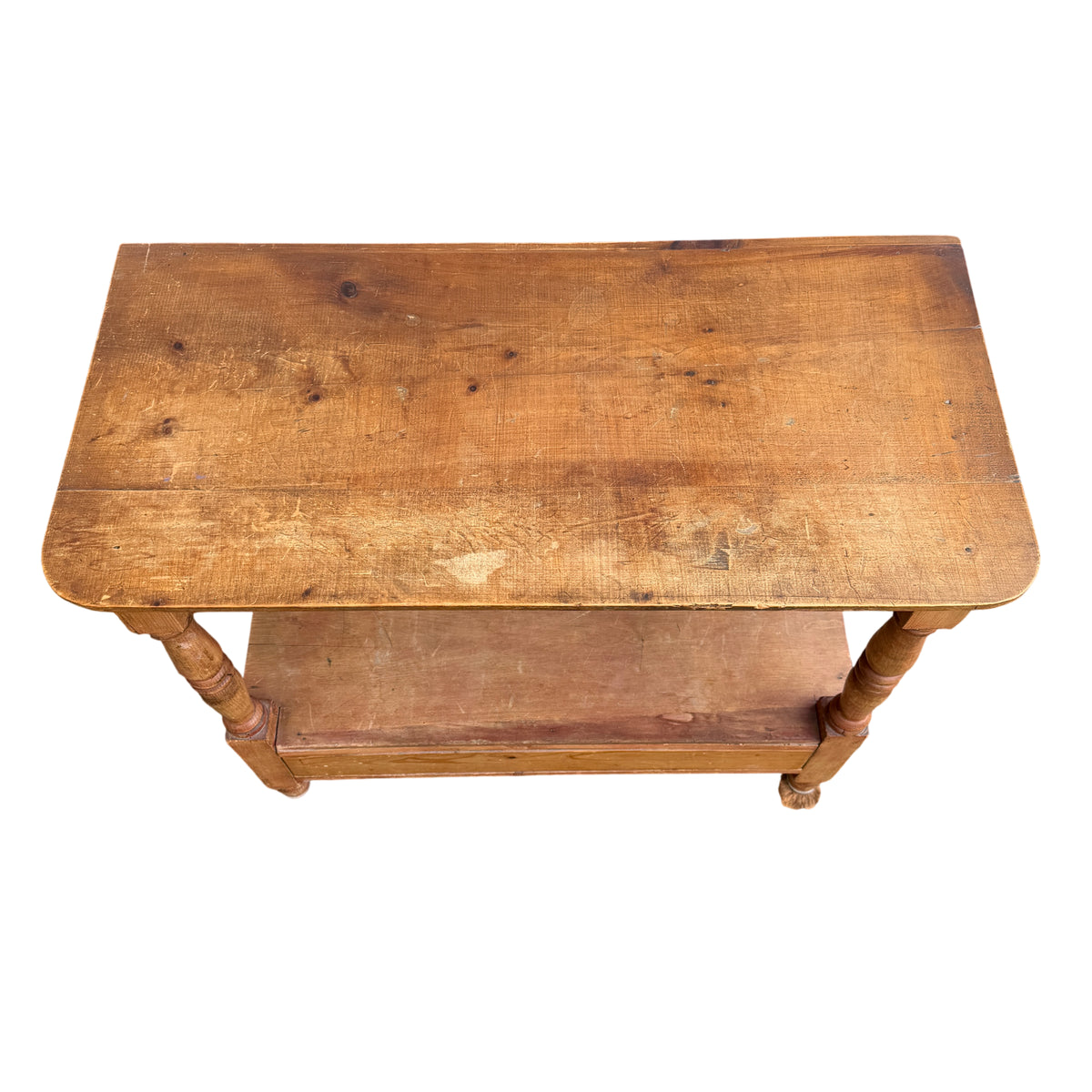 Front view of two-tier pine hall table with turned legs and lower shelf