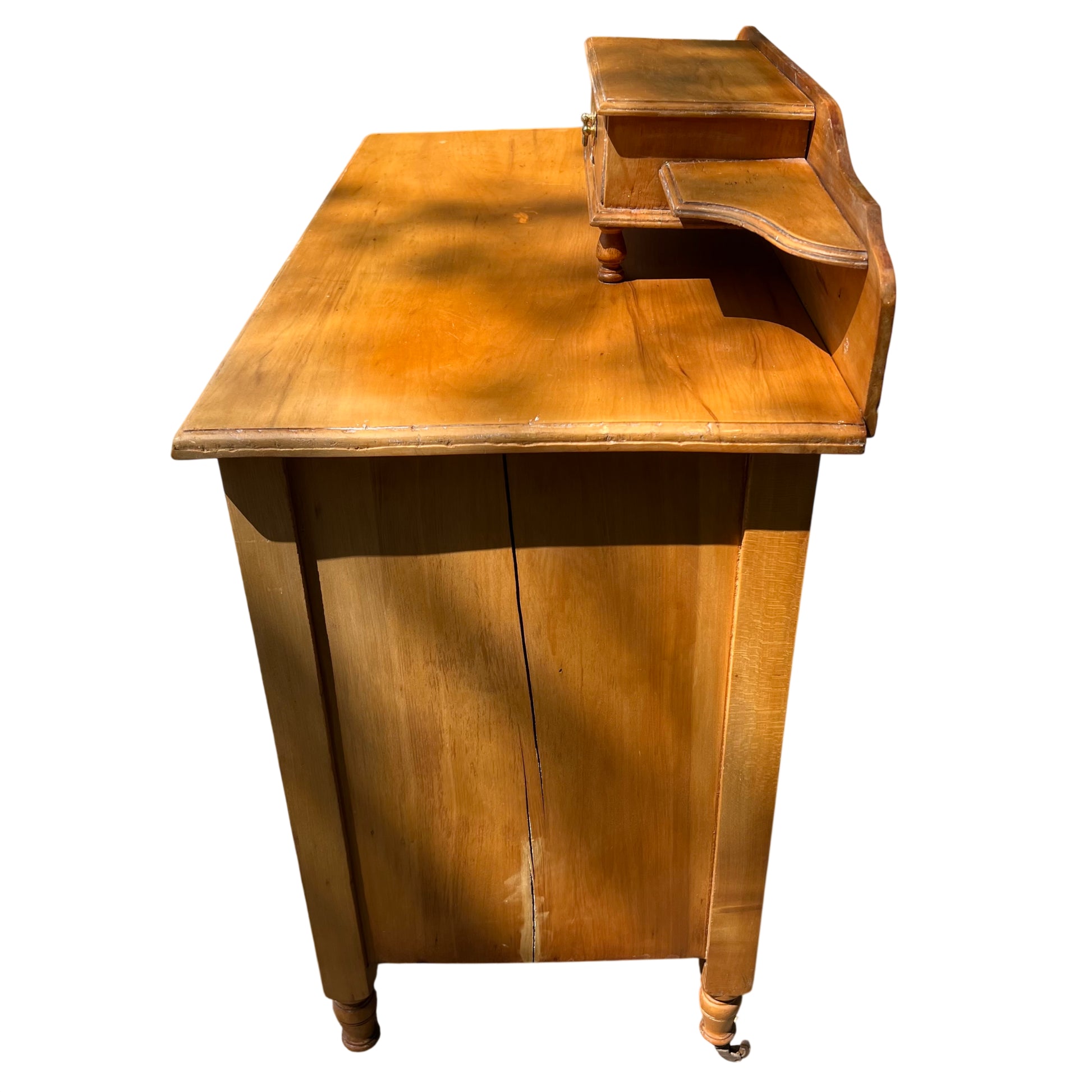 Gallery top with small central drawer raised above the chest surface
