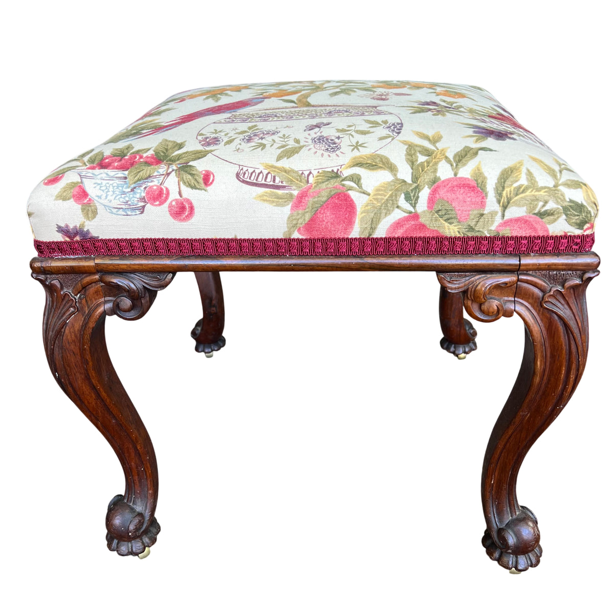 Carved cabriole legs and claw-and-ball feet on a Victorian mahogany stool